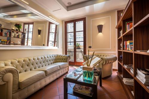 a living room with a couch and a table at Hotel Duomo Firenze in Florence