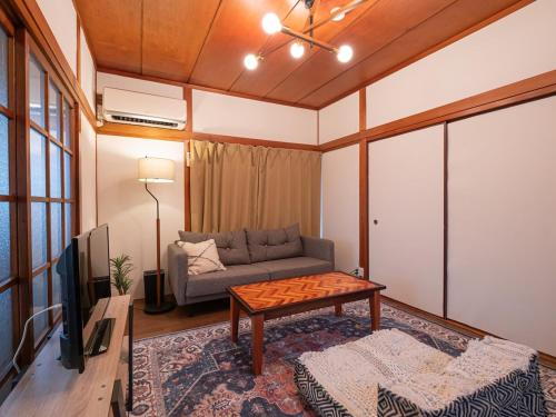 a living room with a couch and a table at 民泊古都 in Takamatsu