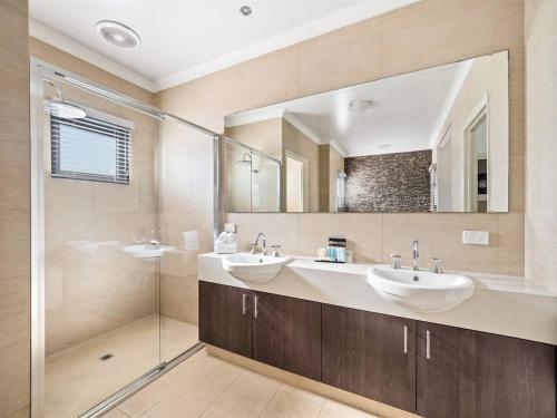 a bathroom with two sinks and a shower at Charlie Bravo Chalet - Escape to the Golden Triangle in Wilyabrup