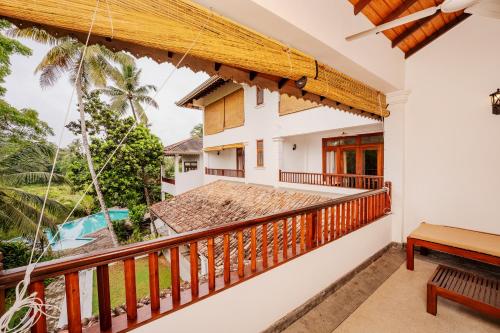 a balcony of a house with a swing at Serenity Boutique - Unawatuna in Unawatuna