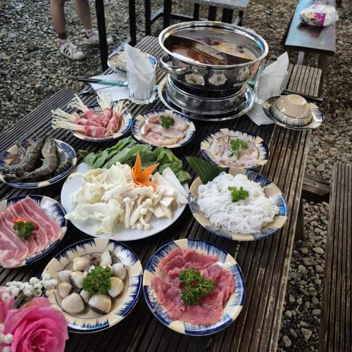 a table full of different types of food on plates at Homestay Thác Liên Khương in Ðưc Trọng