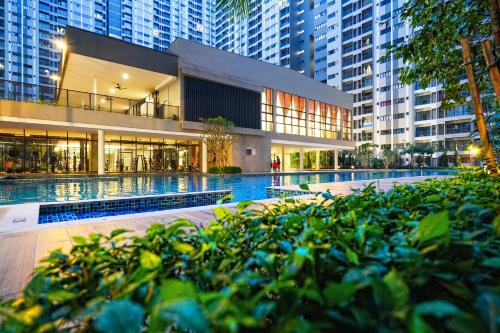 a building with a swimming pool in the middle of a city at Youth City in Nilai
