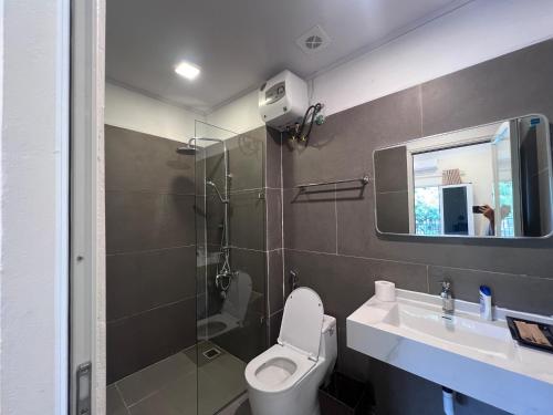 a bathroom with a shower and a toilet and a sink at Lá house Hà Nội in Dong Anh