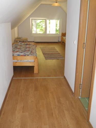 a bedroom with a bed and a wooden floor at Cabana Sestina in Salard