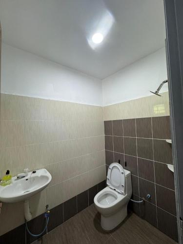 a bathroom with a toilet and a sink at PD GREEN Homestay in Port Dickson