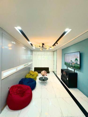 a living room with two bean bags and a tv at TPHomes Lakeview 122 in Ho Chi Minh City