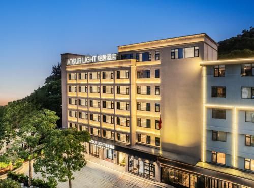 a rendering of a hotel building at dusk at Atour Light Hotel Zhuhai Chimelong Tourist Resort Chimelong Station in Zhuhai