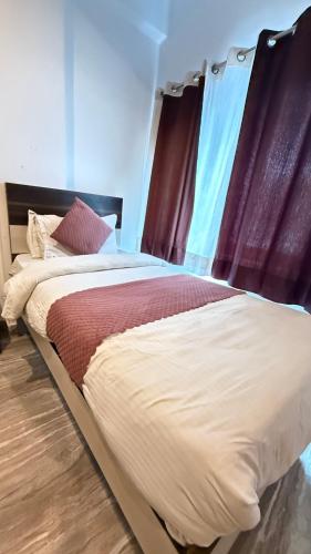 a large bed in a room with at Nahargarh view Hotel in Jaipur