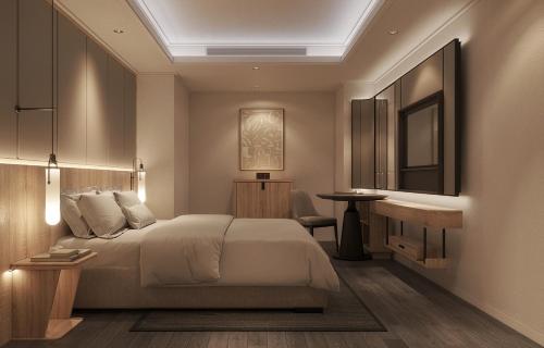 a bedroom with a bed and a table and a mirror at HOTEL du LAC SIGNATURE in Hanoi
