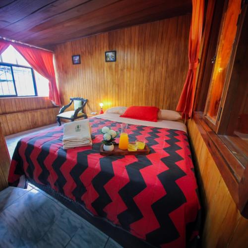 a small room with a bed in a boat at Hostal el Bosque de Mindo in Mindo