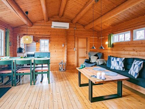 a living room with a couch and a table at 4 person holiday home in Assens in Assens