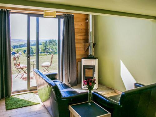 a living room with a couch and a fireplace at Bothy 1 - Uk50471 in Greenhaugh