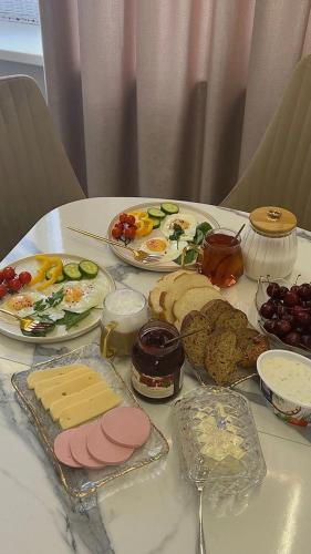 a table with a bunch of food on it at PrestigeVilla in Akchiy