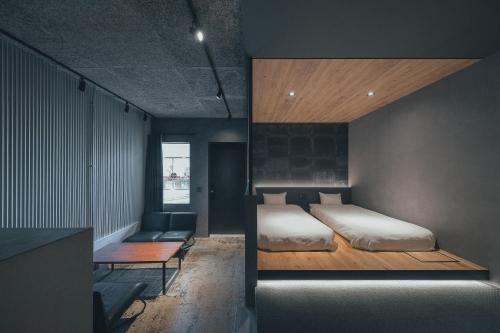 a bedroom with a bed and a couch in it at SEKAI HOTEL Deep Osaka Experience in Osaka