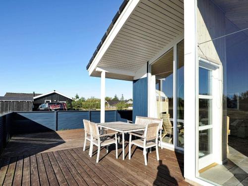 a patio with a table and chairs on a deck at Luxury Retreat near Beach - By Traum Ferienwohnungen in Fanø