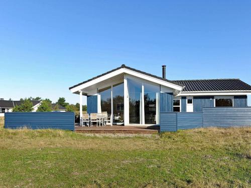 a blue house with a porch and a deck at Luxury Retreat near Beach - By Traum Ferienwohnungen in Fanø