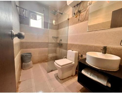a bathroom with a toilet and a sink and a shower at Brijwasi Bhavan vrindavan Omax in Chhatikara
