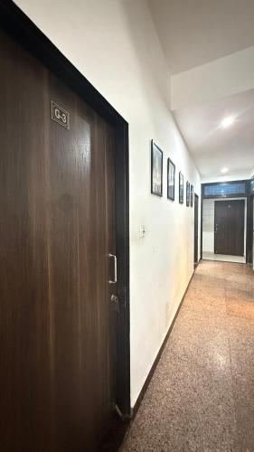 a hallway with a wooden door in a building at Nahargarh view Hotel in Jaipur