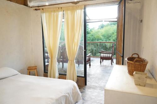une chambre avec un lit et un balcon avec un patio dans l'établissement Eco Finca El Guadual - casa completa, à Manizales