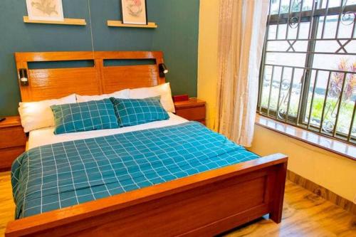 Ένα ή περισσότερα κρεβάτια σε δωμάτιο στο Kigalibnb