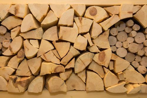 a bunch of wood cut into pieces on a wall at Hotel Cristina in Pinzolo