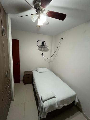 a bedroom with a bed and a ceiling fan at Hospedaje bolognesi in Piura