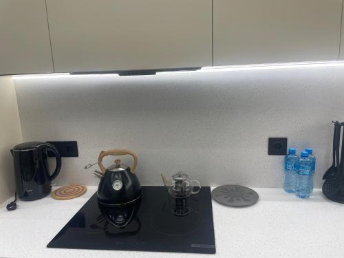 a kitchen counter with a tea kettle on a stove at Sea breeze, studio apartment in Nardaran
