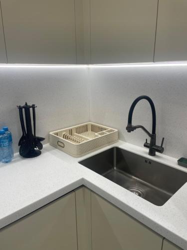 a kitchen counter with a sink and a sink at Sea breeze, studio apartment in Nardaran