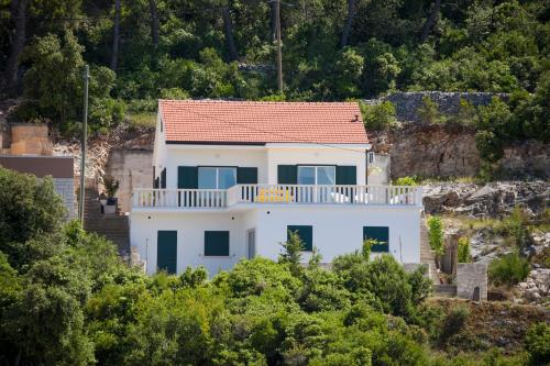 a white house with a red roof at Villa Lav in Prigradica