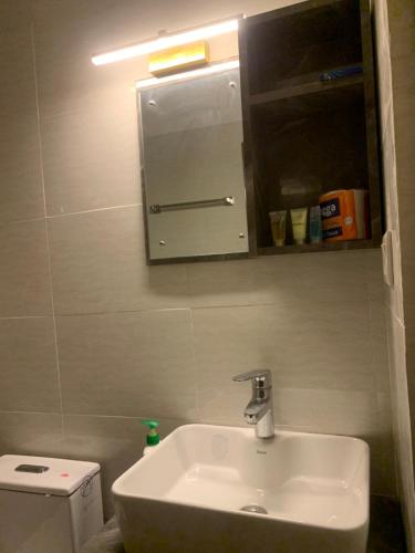 a bathroom with a sink and a mirror and a toilet at 29 Eleven bed and breakfast in Bungmati