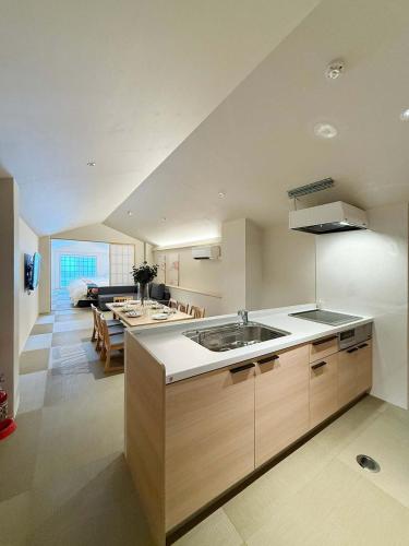a kitchen with a sink and a living room at b hotel Miyajima Omotesando - Sacred Island Stay 31 in Miyajima