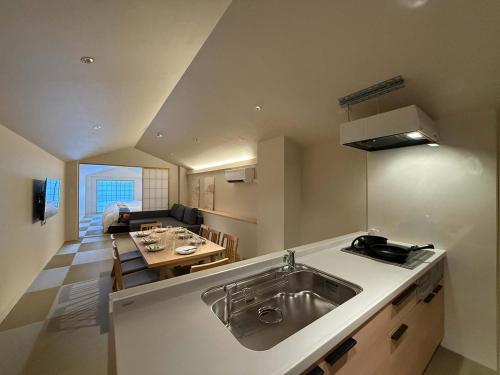 a kitchen with a sink and a living room at b hotel Miyajima Omotesando - Sacred Island Stay 31 in Miyajima