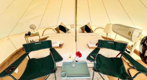 a boat with two chairs and a bed on it at Bangsaen Villa Hotel in Si Racha