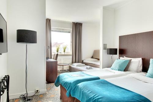 
Cama o camas de una habitación en ProfilHotels Hotel Garden
