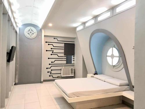 a bedroom with a bed and a mirror at Astrotel Cebu in Cebu City