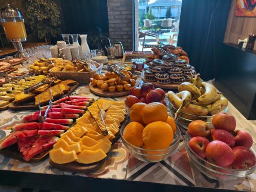 a buffet of different types of food on a table at Hotel Vojvoda Putnik in Vranje