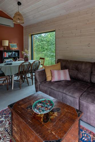 a living room with a couch and a table at Getlost cabins in Valanciunai