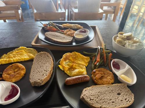 a table with two trays of breakfast food on it at 29 Eleven bed and breakfast in Bungmati