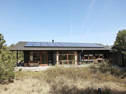 a house with solar panels on the roof at Cozy Beach House with Spa - By Traum Ferienwohnungen in Torup Strand