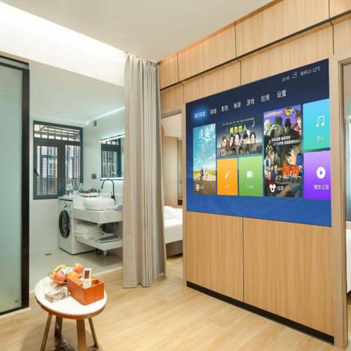 a hospital room with a bed and a large screen at Chengxing Hotel Apartment (Wanyue City Plaza Branch) in Lung Wa