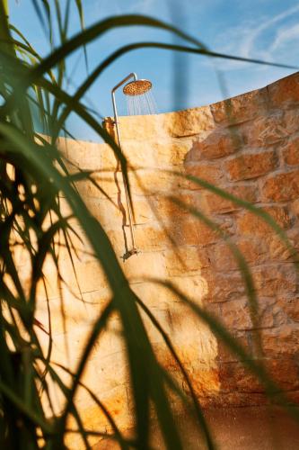 a shower on the side of a brick wall at Apartments Vineyard19 in Retz