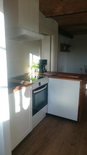 a kitchen with a stove and a counter top at Aagaarden in Billund