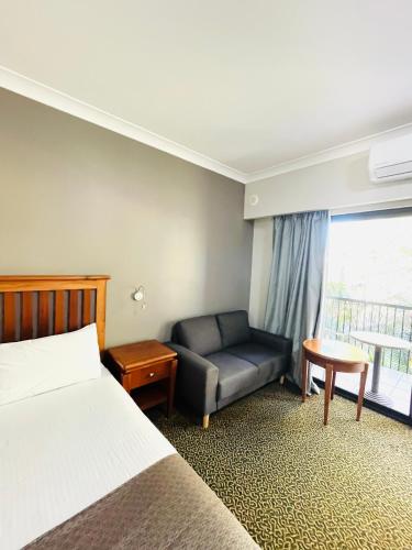a hotel room with a bed and a couch at Comfort Inn Grafton in Grafton