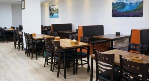a dining room with wooden tables and chairs at Novalus Tourist Hotel in Seoul