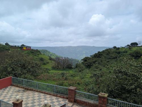 a balcony with a view of a mountain at RedRock Villa in Mahabaleshwar