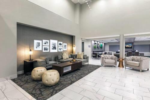 a lobby with couches and chairs and a table at Wingate Augusta Washington Road by Wyndham in Augusta