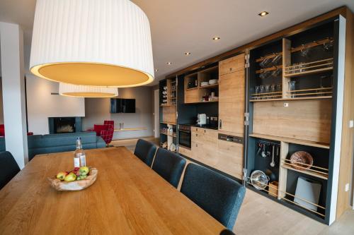 a dining room with a wooden table and chairs at Das.Hochgrat in Oberstaufen