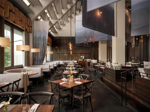 a restaurant with tables and chairs in a room at The Starling Atlanta Midtown, Curio Collection by Hilton in Atlanta