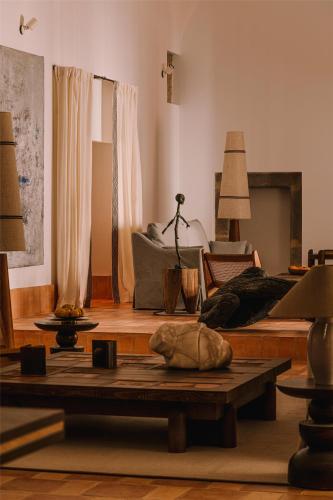 a living room with a couch and a table at Palacio De Godoy Caceres, Curio Collection By Hilton in Cáceres