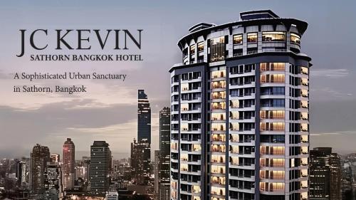 a poster of a tall building in a city at JC Kevin Sathorn Bangkok Hotel in Bangkok
